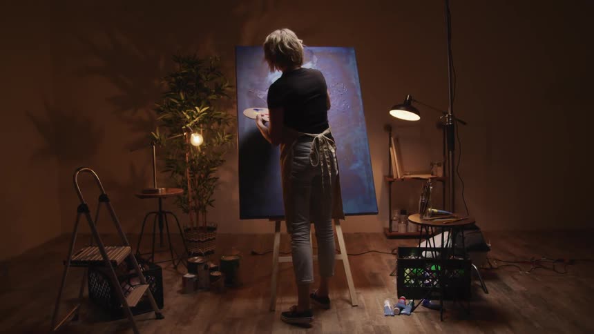 A woman is painting indoors