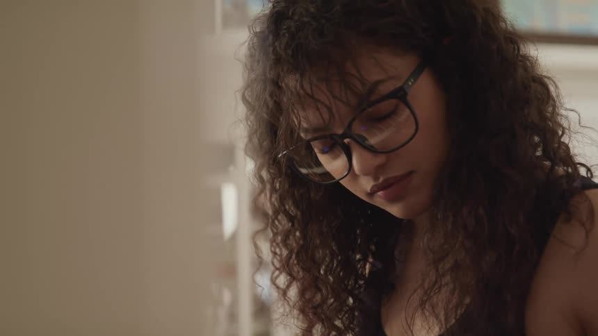 A teenage girl at home with her eyes closed as she concentrates