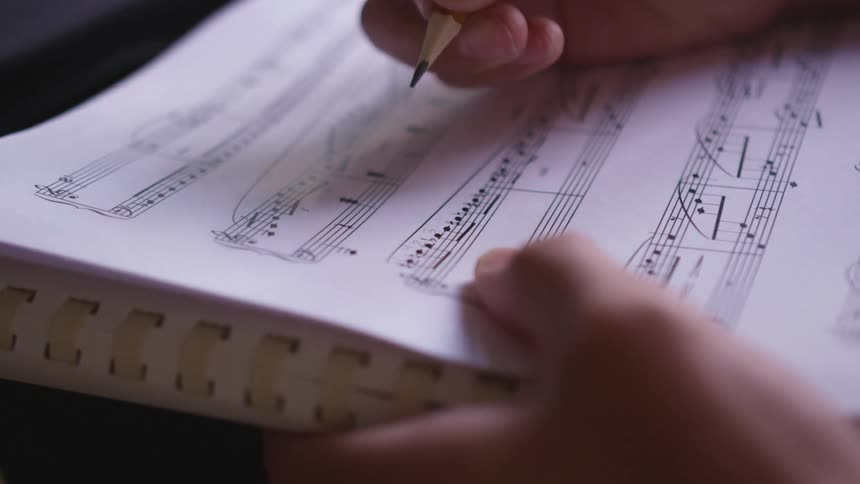 A person is writing music