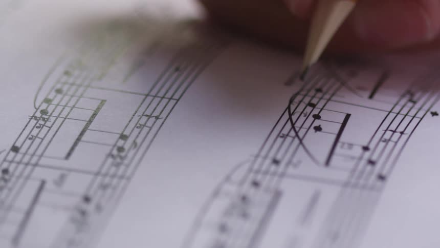 Markings are added to sheet music with a pencil