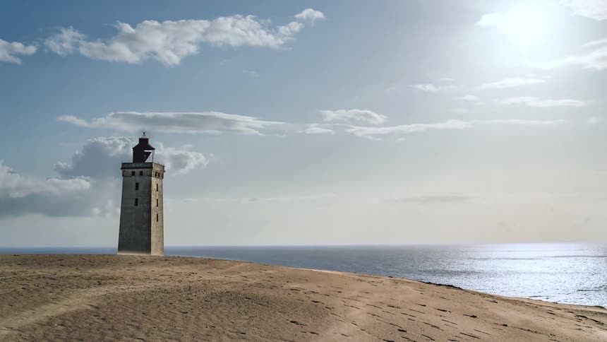 Time lapse of clouds moving over a lighthouse on the shore