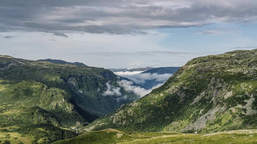 Clouds floating over a mountain landscape on a summer day