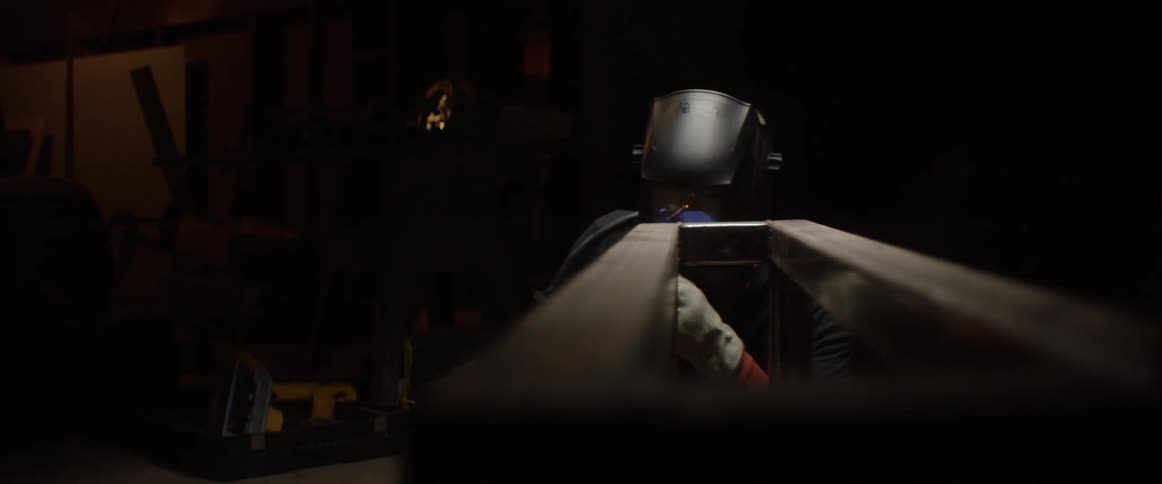 A man is welding metal before opening his welding mask