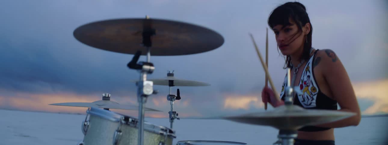 A woman is playing the drums outdoors in an arctic area