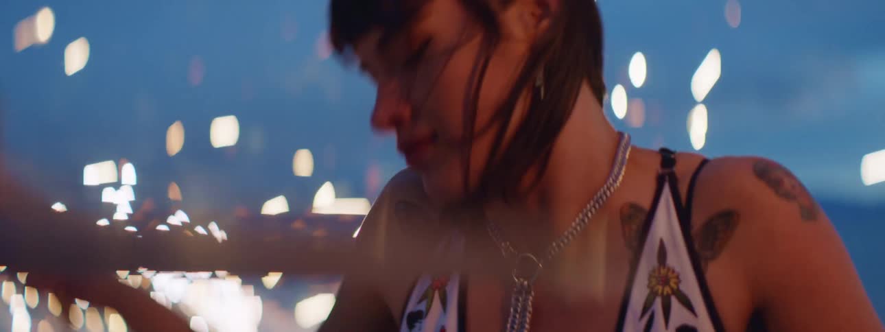 A teenage girl plays the drums as spark fly all around her
