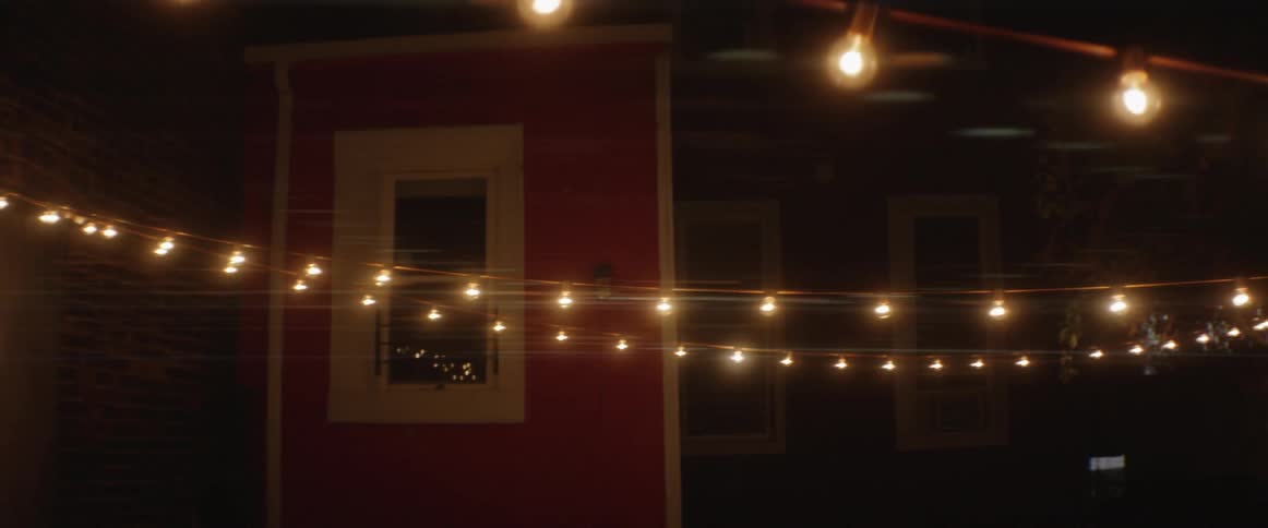 Lights are hung between some homes at night