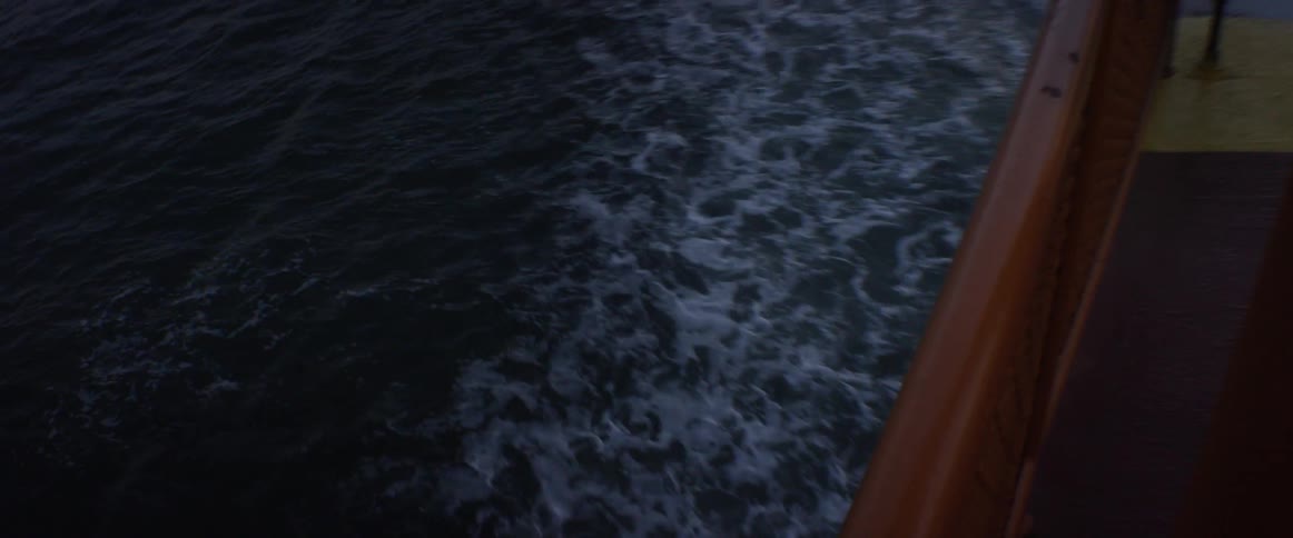 Water is passing behind a moving boat