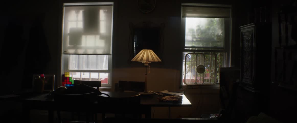 A lamp shines inside a home