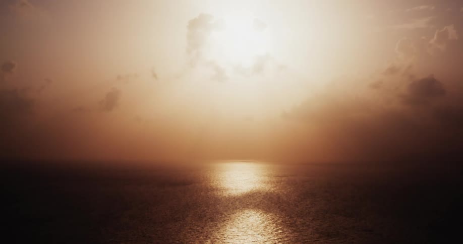 The ocean at sunrise with the sky in the horizon