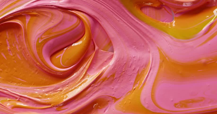Paint being swirled together with a paint brush