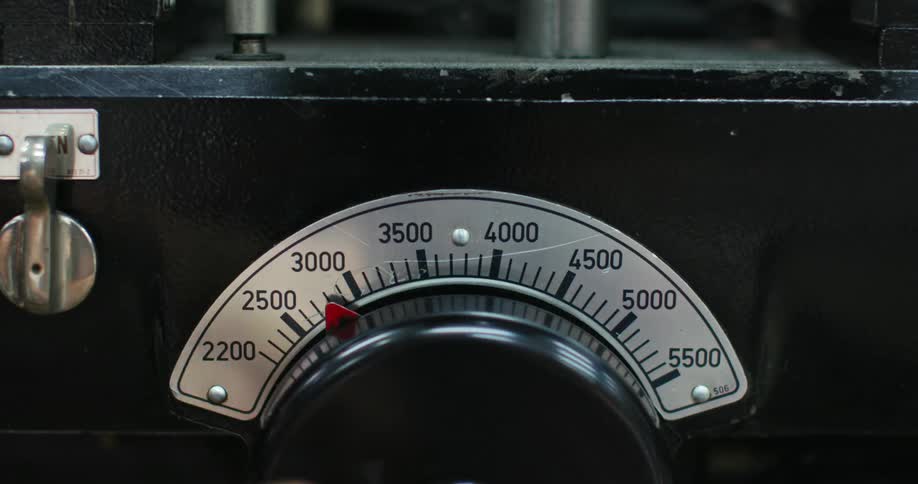 A person turns a dial and moves a gauge