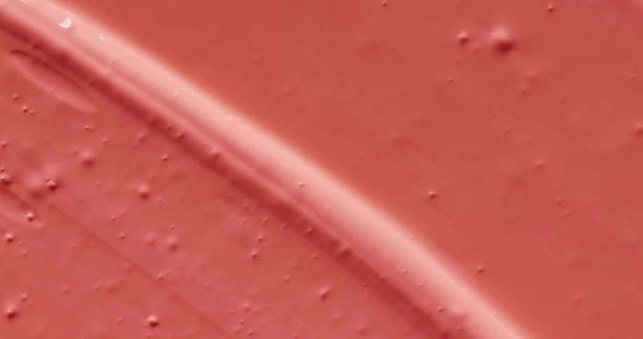 A paint brush painting with pink paint
