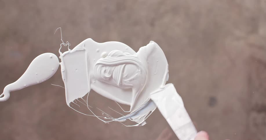 A person is mixing white paint