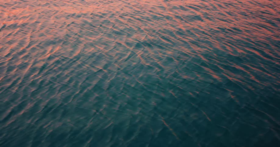The water moves slowly under the light