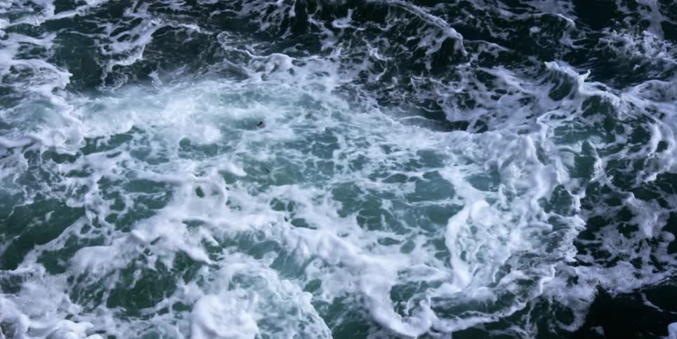 Ocean waves swaying back and forth outdoors during the day