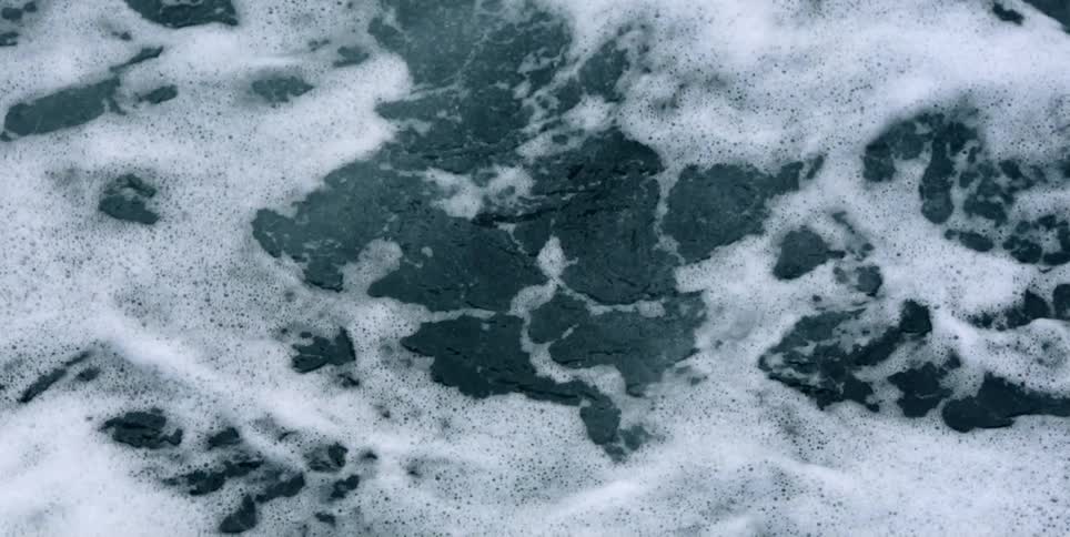 A foamy ocean wave crashing in the sea