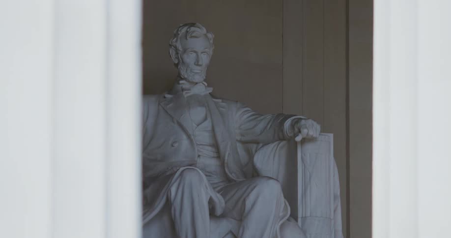 A statue of abraham lincoln at the lincoln memorial in washington dc during the day