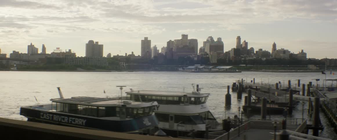 Moving past a pier with boats docked