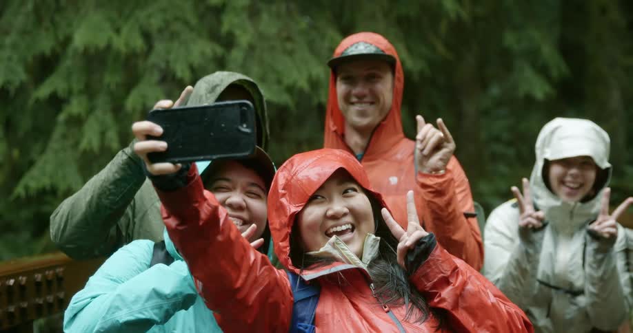 A group of friends pose for a selfie while taking a hiking trip