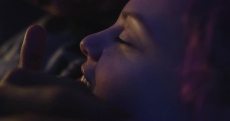 A person traces his finger on a womans face