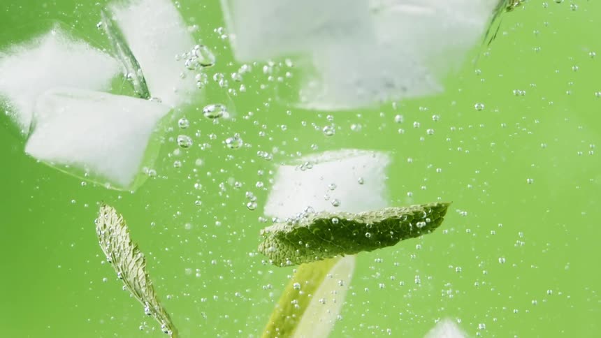 Limes ice and mint falling in to a mojito