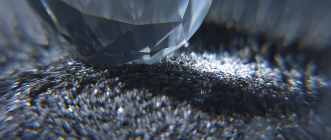 Metal fillings moving under a magnetic field around a glass prism