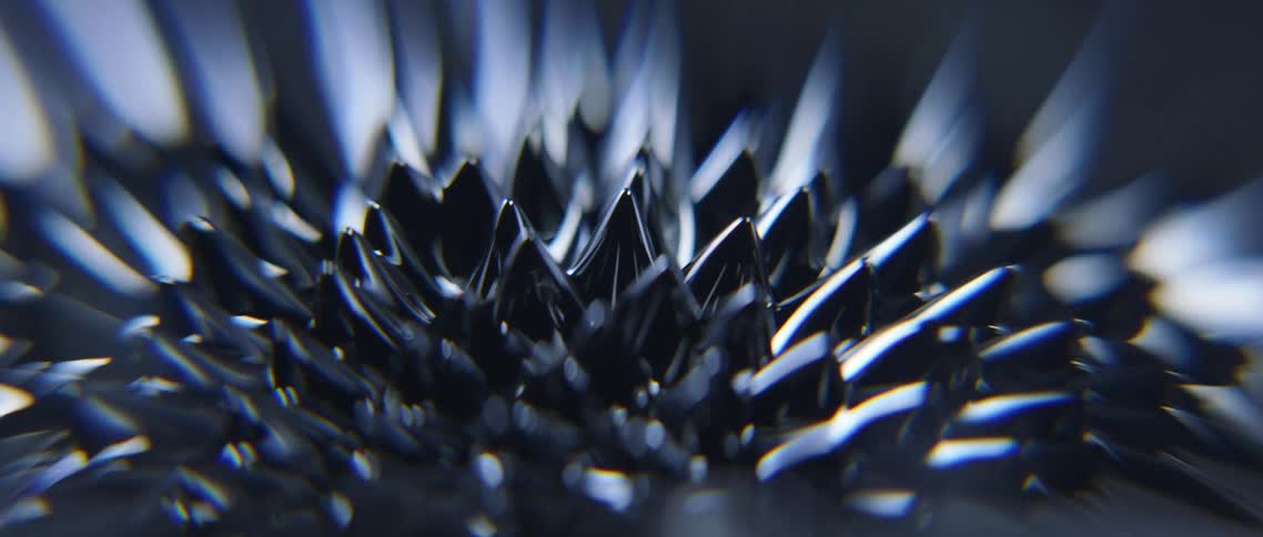 Conical spikes develop from smooth silver grey surface before fading away