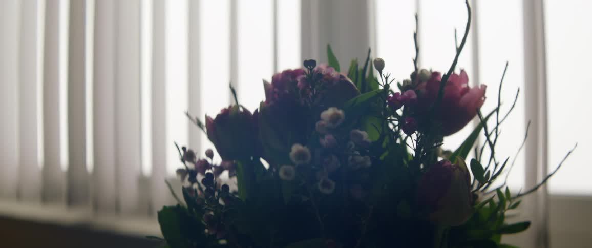 A backlit flower bouquet in a hospital room