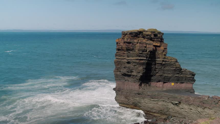 Waves crashing in to a cliff in the ocean