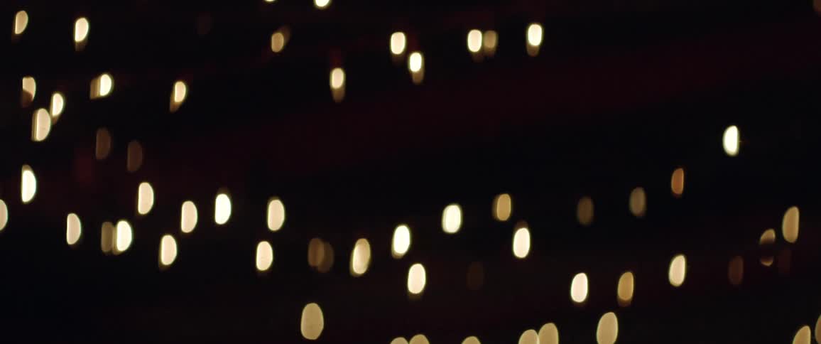 String lights hanging in the ceiling of a dark bar