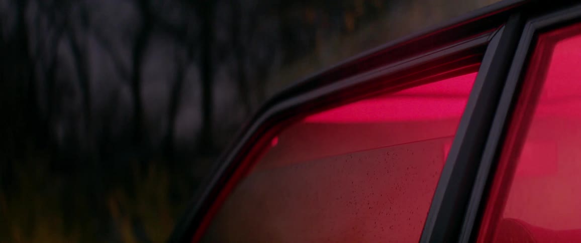 Smoke billows out of a car window, glowing red from inside