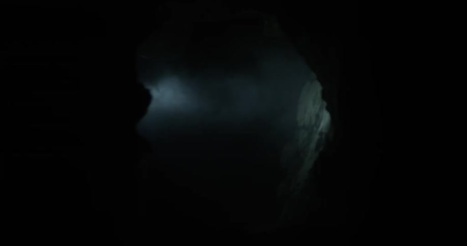 A light is shown down a dark passageway
