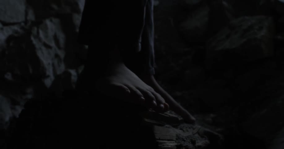 Bare feet balance on rocks at night