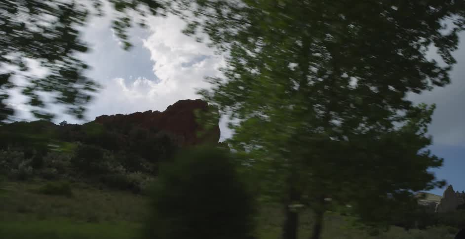 Clouds hover over rock formations in the wilderness
