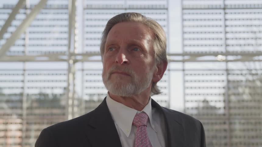 Close up of a professional senior mans face wearing a suit and necktie