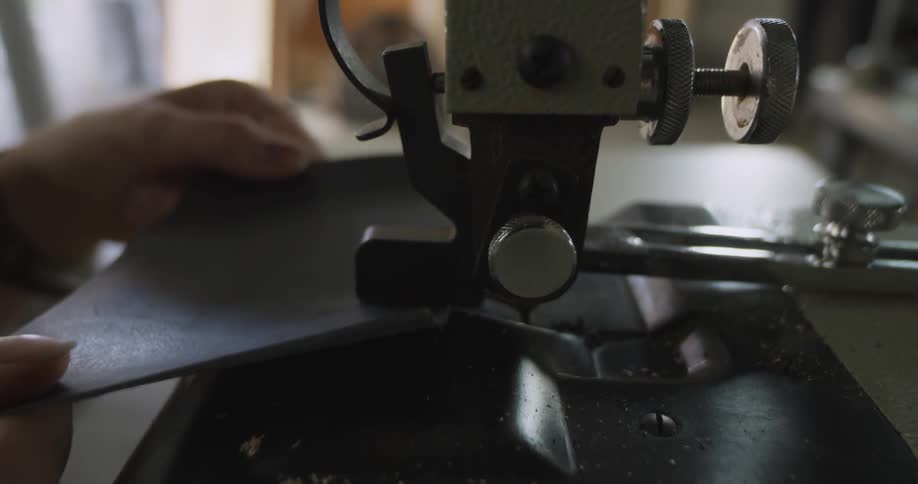 A person runs a sheet through a machine