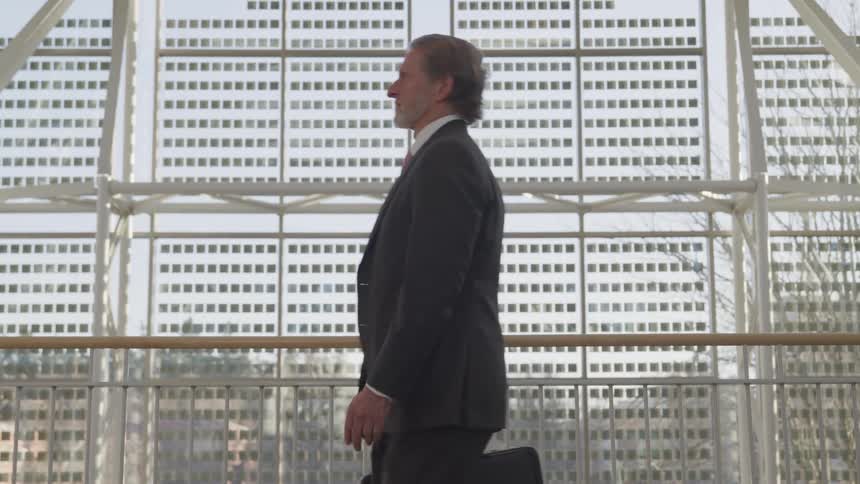 A man is walking in a downtown city