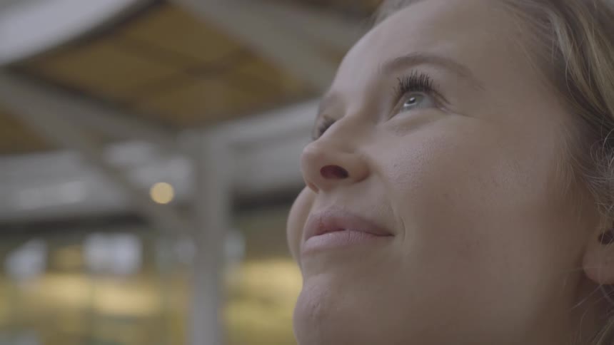 Close up of a teenage girls face beaming with pleasure and looking up