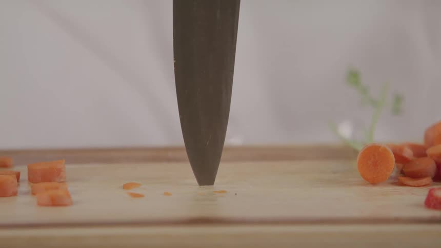 A chef stabs his knife into the cutting board