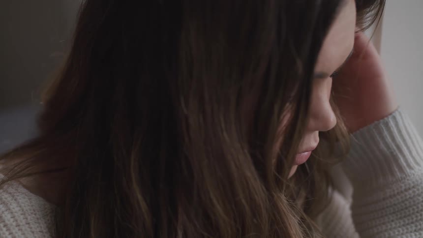 Close up of a womans head with hair covering her face