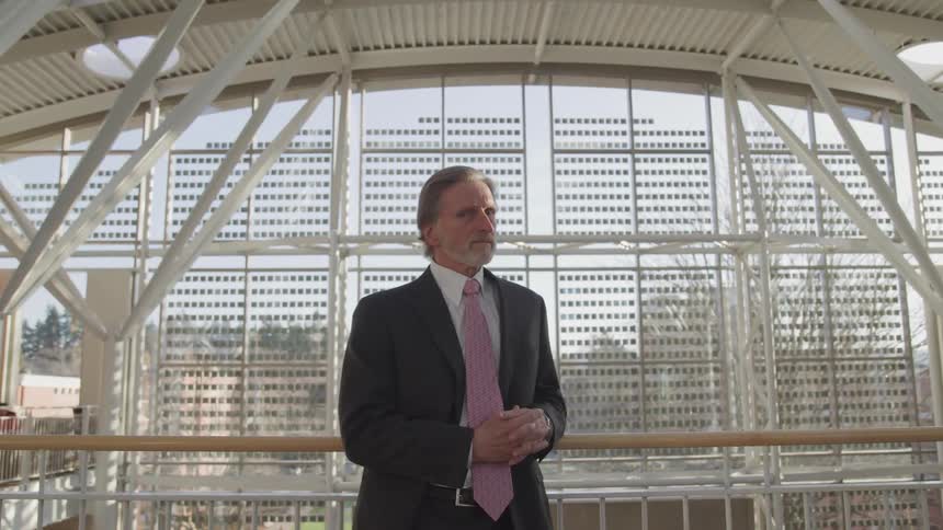A man in a suit standing in an office building
