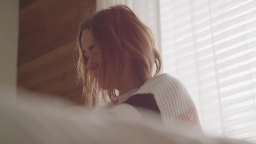 A woman is standing inside a house