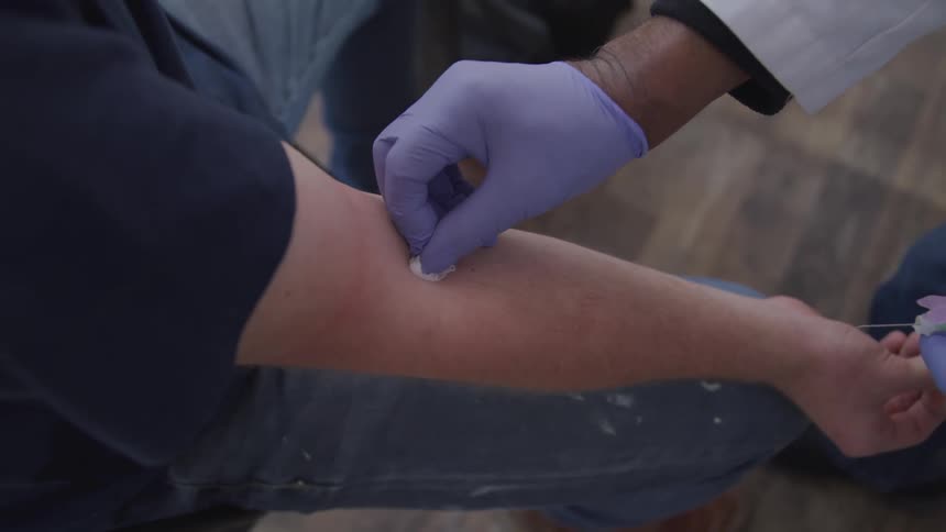 Doctor gives patient injection inside elbow joint