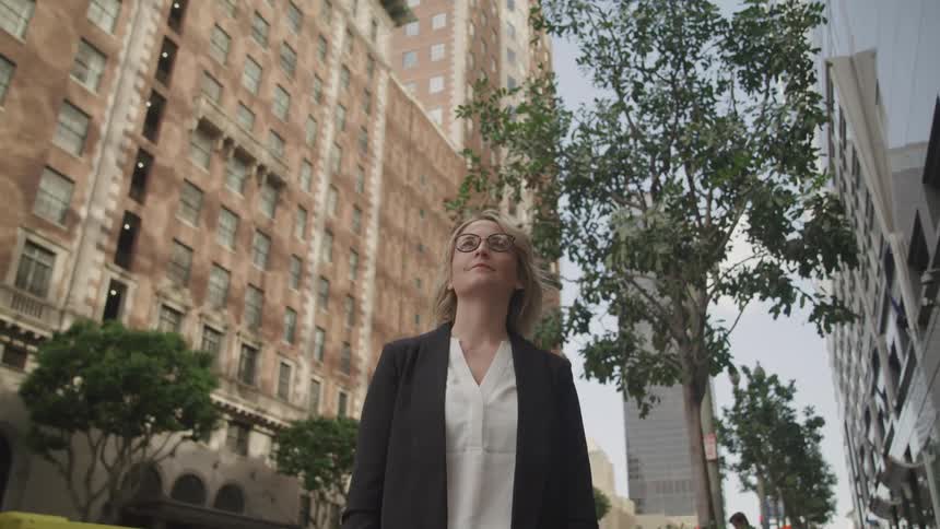 A woman is walking in a downtown city