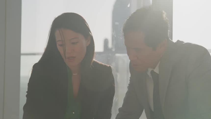 Two coworkers talking in an office