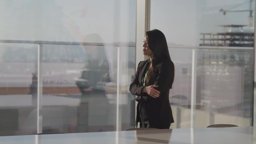 A woman is walking in an office