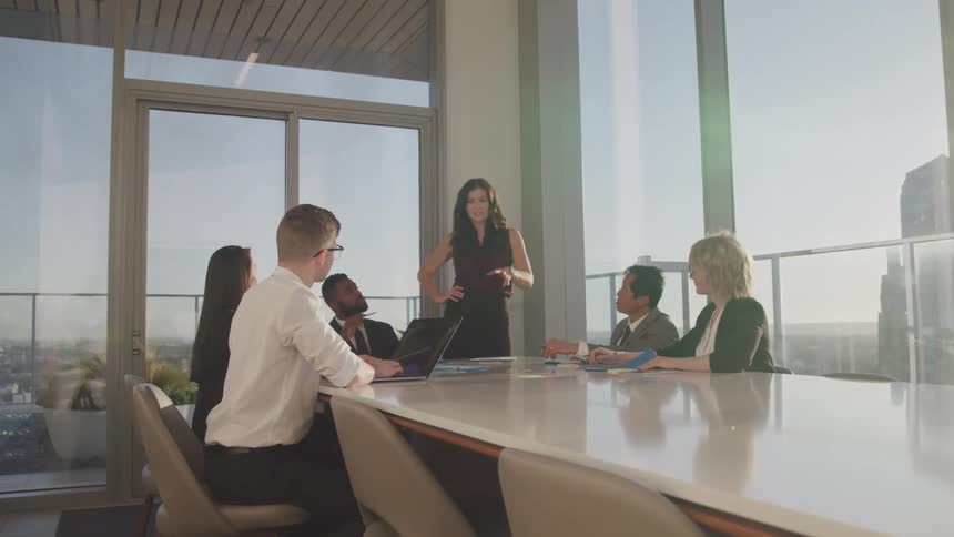 Group of business people on a meeting room at sunset