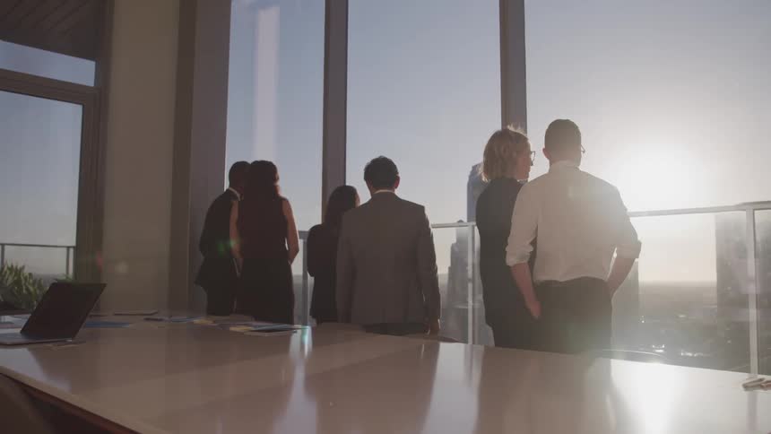 A group of coworkers watch the sunrise together