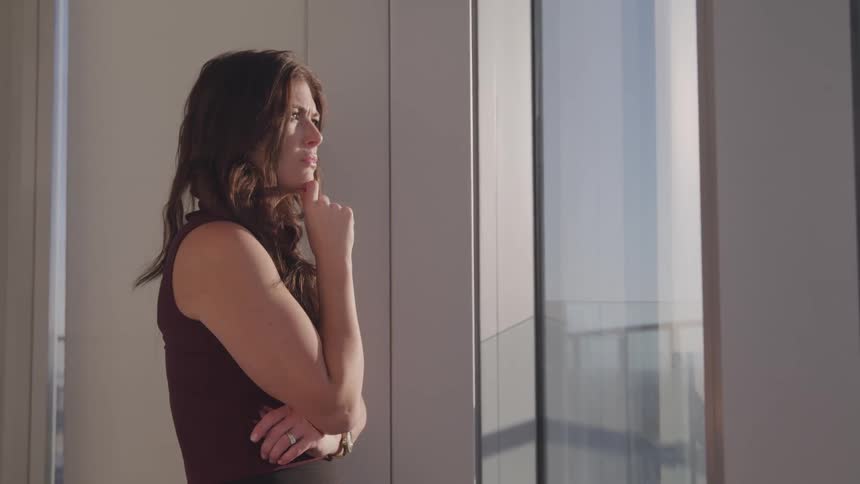 A woman is looking out the window