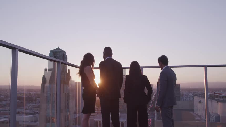 People watch the sunrise over the city